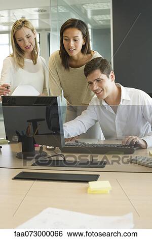 Colleagues working together in office View Large Photo Image Stock Photograph - Colleagues working together in office. Fotosearch