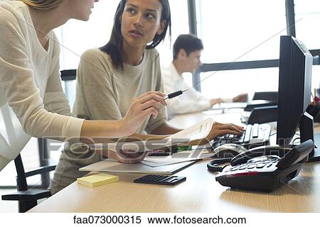 Colleagues working together in office View Large Photo Image Stock Photography - Colleagues working together in office. Fotosearch