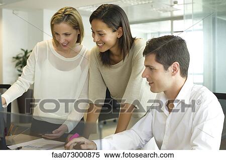 Colleagues working together in office View Large Photo Image Stock Photography - Colleagues working together in office. Fotosearch