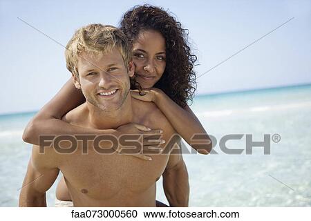 Stock Image - Couple at the beach, portrait. Fotosearch