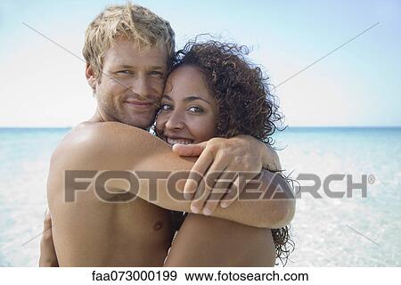 Couple embracing at the beach, portrait View Large Photo Image Stock Photo - Couple embracing at the beach, portrait. Fotosearch