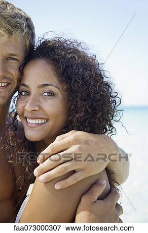 Couple embracing at the beach, portrait View Large Photo Image Stock Photo - Couple embracing at the beach, portrait. Fotosearch