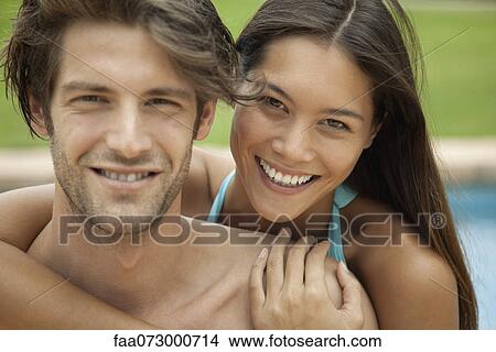 Couple embracing outdoors, portrait View Large Photo Image Picture - Couple embracing outdoors, portrait. Fotosearch