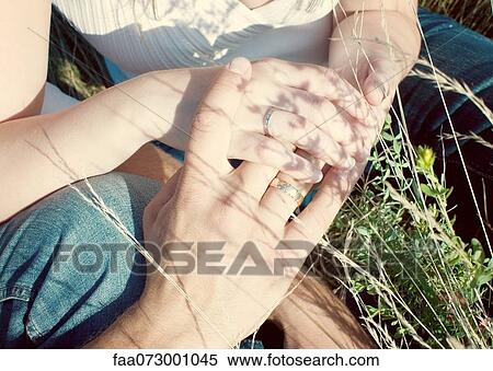 Couple holding hands, cropped View Large Photo Image Stock Photography - Couple holding hands, cropped. Fotosearch
