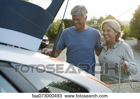 Couple loading bags into car View Large Photo Image Stock Image - Couple loading bags into car. Fotosearch