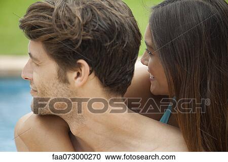 Couple outdoors, both looking over their shoulders View Large Photo Image Stock Image - Couple outdoors, both looking over their shoulders. Fotosearch