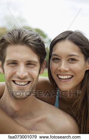 Stock Photo - Couple outdoors, portrait. Fotosearch