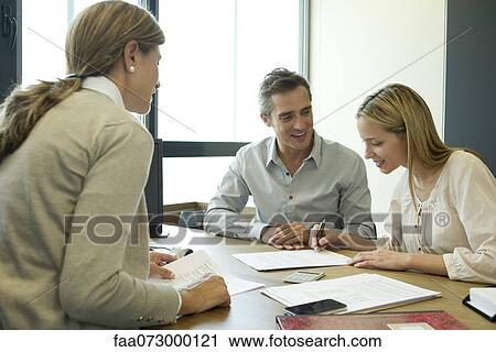 Couple reading over contract in office View Large Photo Image Stock Image - Couple reading over contract in office. Fotosearch