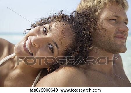 Couple relaxing at the beach, portrait View Large Photo Image Stock Image - Couple relaxing at the beach, portrait. Fotosearch