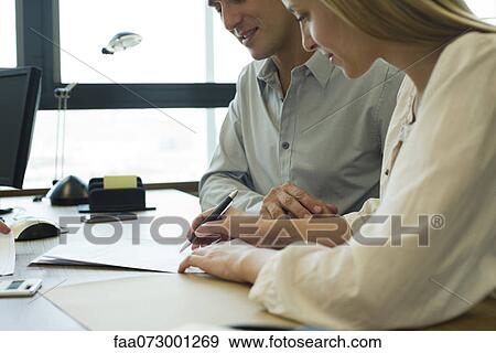 Couple signing contract View Large Photo Image Stock Photo - Couple signing contract. Fotosearch