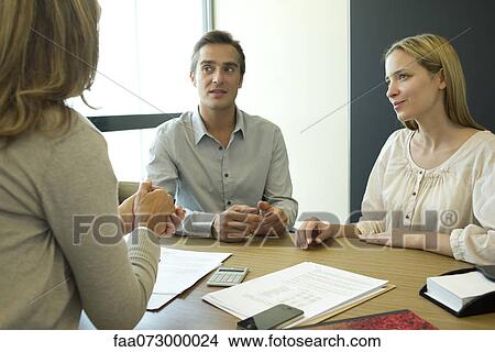 Couple talking with financial advisor View Large Photo Image Picture - Couple talking with financial advisor. Fotosearch