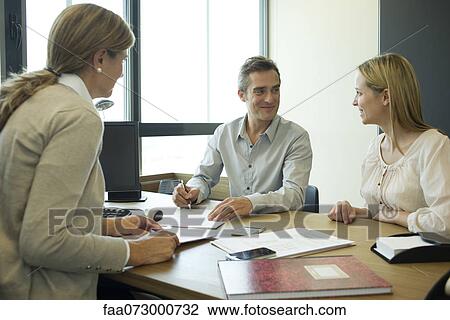 Couple talking with financial advisor View Large Photo Image Stock Image - Couple talking with financial advisor. Fotosearch