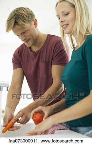 Couple washing vegetables together in kitchen View Large Photo Image Stock Image - Couple washing vegetables together in kitchen. Fotosearch