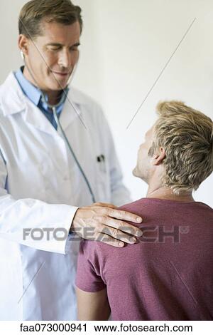 Doctor talking with patient during exam View Large Photo Image Stock Image - Doctor talking with patient during exam. Fotosearch