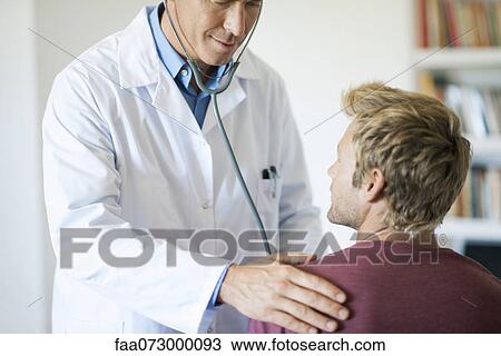 Doctor using stethoscope on patient View Large Photo Image Stock Image - Doctor using stethoscope on patient. Fotosearch