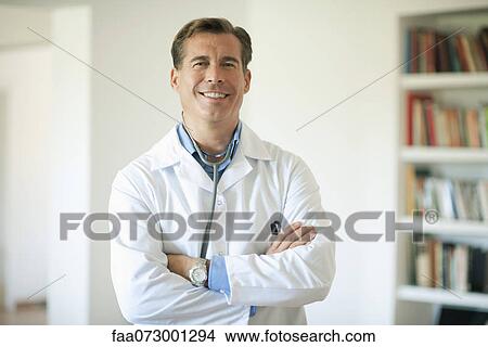 Doctor with arms folded, portrait View Large Photo Image Picture - Doctor with arms folded, portrait. Fotosearch