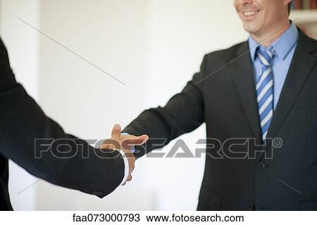 Stock Image - Executives shaking hands. Fotosearch