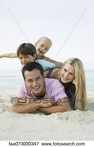 Stock Photo - Family posing together at the beach, portrait. Fotosearch