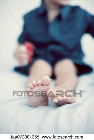 Stock Photography - Feet of little boy low section. Fotosearch