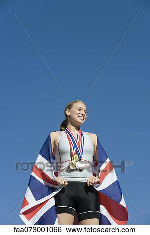 Female athlete being honored on podium View Large Photo Image Stock Photograph - Female athlete being honored on podium. Fotosearch