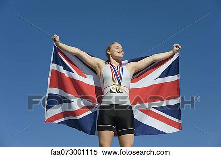 Female athlete being honored on podium, holding up British flag View Large Photo Image Stock Photography - Female athlete being honored on podium, holding up British flag. Fotosearch