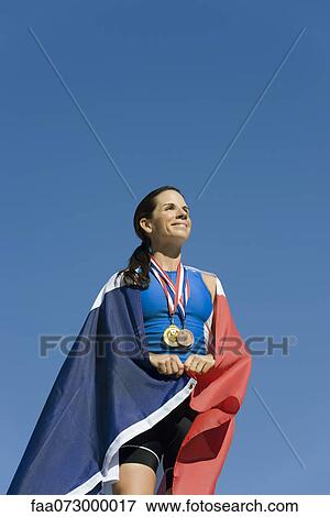 Female athlete on winner's podium, wrapped in French flag View Large Photo Image Stock Photo - Female athlete on winner's podium, wrapped in French flag. Fotosearch