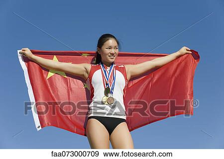 Female athlete on winner's podium, holding Chinese flag View Large Photo Image Stock Photo - Female athlete on winner's podium, holding Chinese flag. Fotosearch