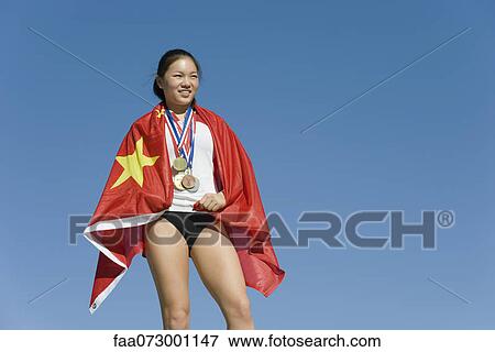 Female athlete on winner's podium, wrapped in Chinese flag View Large Photo Image Stock Photo - Female athlete on winner's podium, wrapped in Chinese flag. Fotosearch