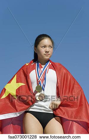 Female athlete on winner's podium, wrapped in Chinese flag View Large Photo Image Stock Photo - Female athlete on winner's podium, wrapped in Chinese flag. Fotosearch