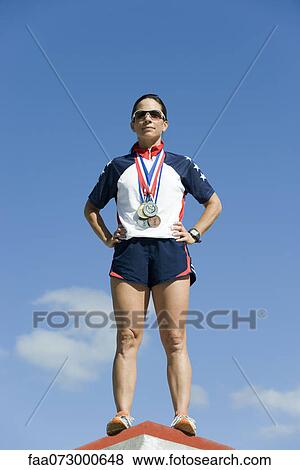 Female athlete standing on winner's podium View Large Photo Image Stock Photo - Female athlete standing on winner's podium. Fotosearch