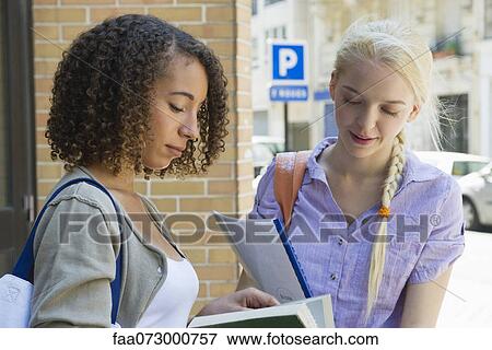 Stock Photo - Female college students studying outdoors. Fotosearch
