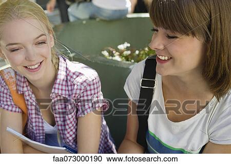 Female friends chatting outdoors View Large Photo Image Stock Image - Female friends chatting outdoors. Fotosearch