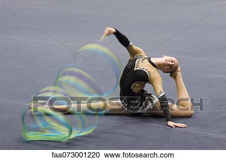 Female gymnast performing floor routine with ribbon View Large Photo Image Stock Image - Female gymnast performing floor routine with ribbon. Fotosearch