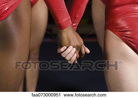 Female gymnasts holding hands, mid section View Large Photo Image Stock Image - Female gymnasts holding hands, mid section. Fotosearch
