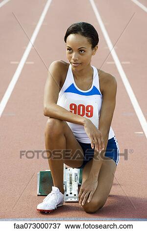Female runner crouched at starting line View Large Photo Image Stock Photo - Female runner crouched at starting line. Fotosearch