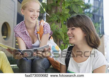 Friends taking break outdoors View Large Photo Image Stock Image - Friends taking break outdoors. Fotosearch