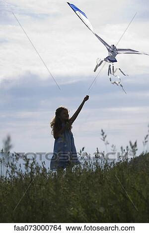 Picture - Girl flying kite. Fotosearch