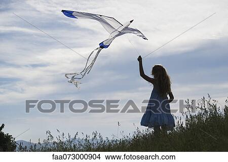 Girl flying kite View Large Photo Image Picture - Girl flying kite. Fotosearch