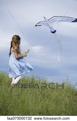 Girl flying kite View Large Photo Image Stock Image - Girl flying kite. Fotosearch
