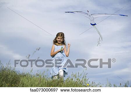 Girl flying kite View Large Photo Image Stock Photo - Girl flying kite. Fotosearch