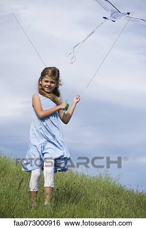 Girl flying kite View Large Photo Image Stock Photograph - Girl flying kite. Fotosearch