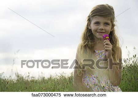 Girl holding bouquet of wildflowers, portrait View Large Photo Image Stock Photography - Girl holding bouquet of wildflowers, portrait. Fotosearch