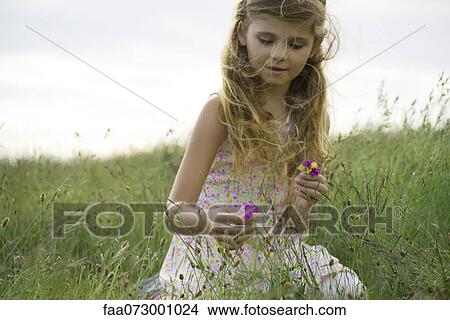 Picture - Girl picking wildflowers. Fotosearch