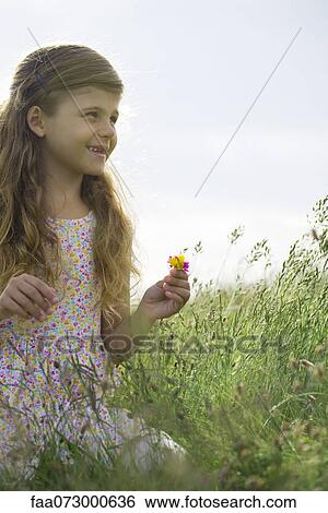 Girl picking wildflowers View Large Photo Image Stock Photograph - Girl picking wildflowers. Fotosearch