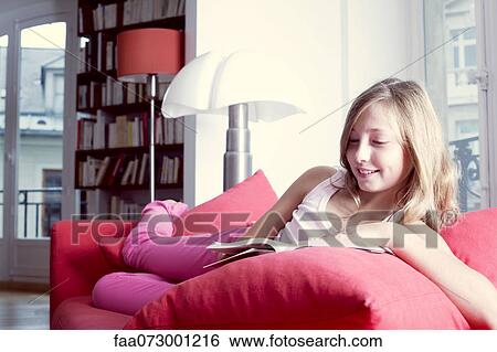 Girl relaxing on couch reading book View Large Photo Image Stock Photograph - Girl relaxing on couch reading book. Fotosearch