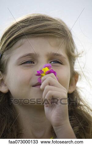 Girl smelling flowers, portrait View Large Photo Image Stock Image - Girl smelling flowers, portrait. Fotosearch
