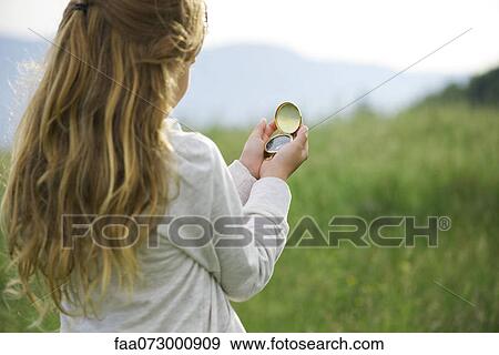 Girl using compass View Large Photo Image Stock Photo - Girl using compass. Fotosearch