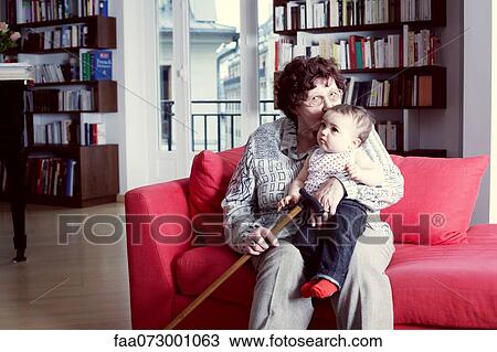 Grandmother kissing granddaughter, portrait View Large Photo Image Stock Image - Grandmother kissing granddaughter, portrait. Fotosearch