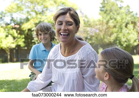 Grandmother laughing with grandchildren View Large Photo Image Picture - Grandmother laughing with grandchildren. Fotosearch