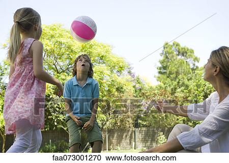 Grandmother watching grandchildren playing with ball View Large Photo Image Stock Image - Grandmother watching grandchildren playing with ball. Fotosearch